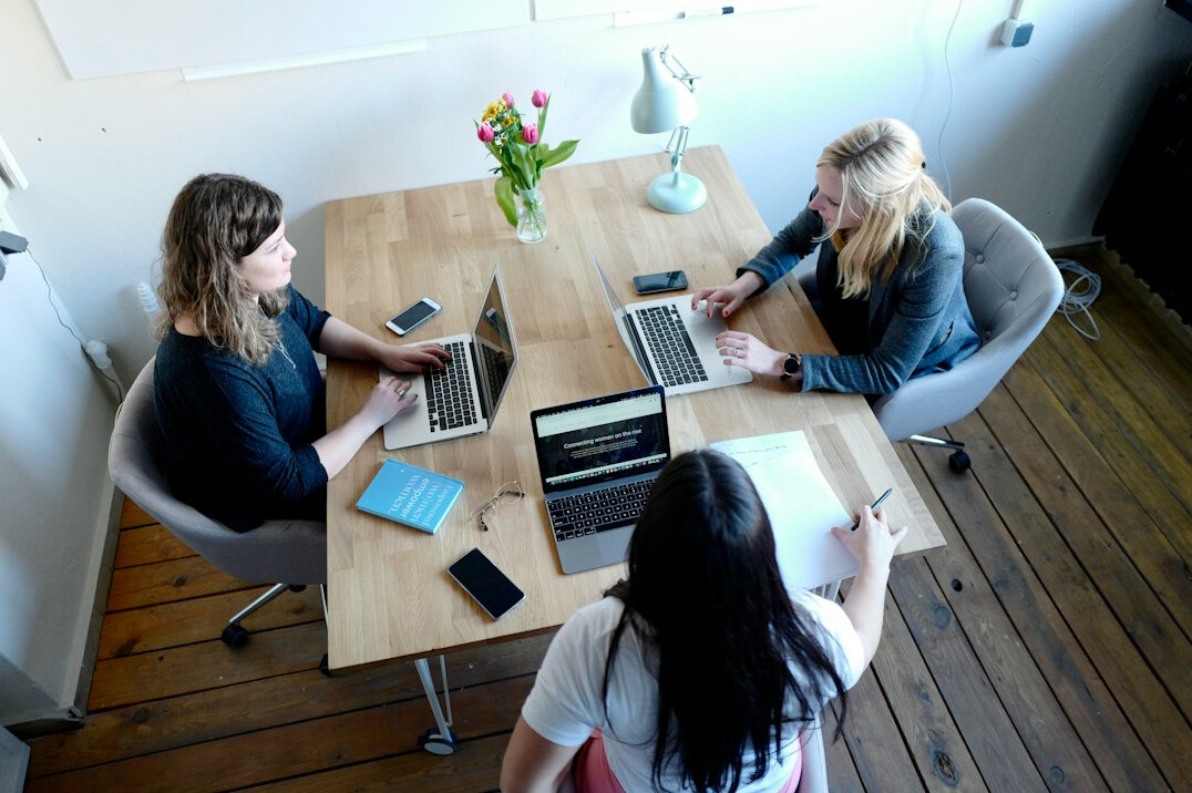 group of friends discussing at table
