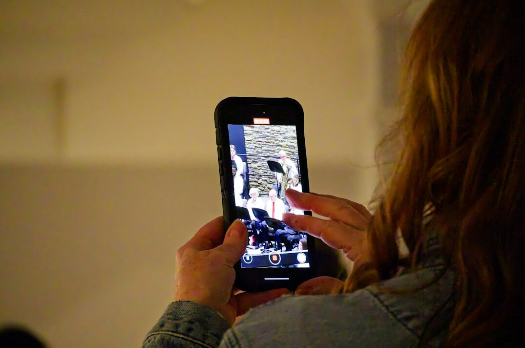 Student testing a mobile app prototype on a smartphone
