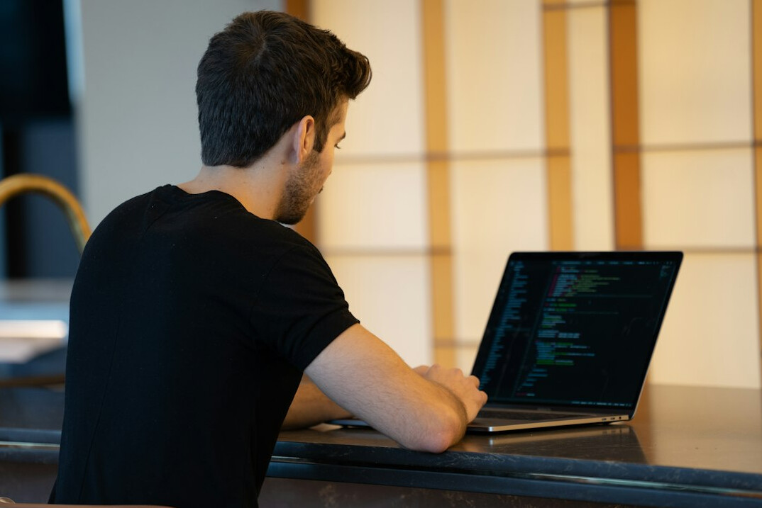 person studying coding on laptop